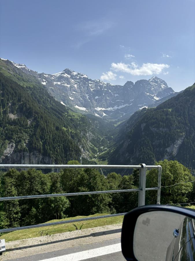 A deep green valley under snow-capped peaks in Switzerland